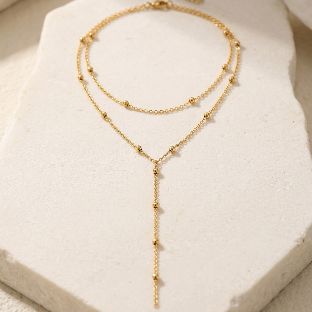 Gold-tone layered necklace styled on ivory stone