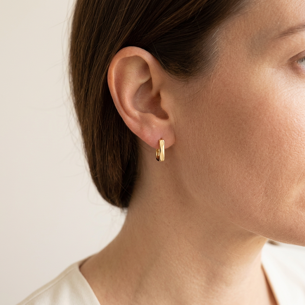 Gold earrings worn by a white woman
