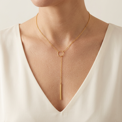 Gold lariat necklace on a model