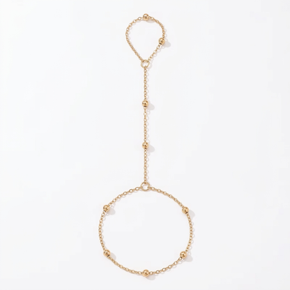 Gold-tone hand chain on a clean white background