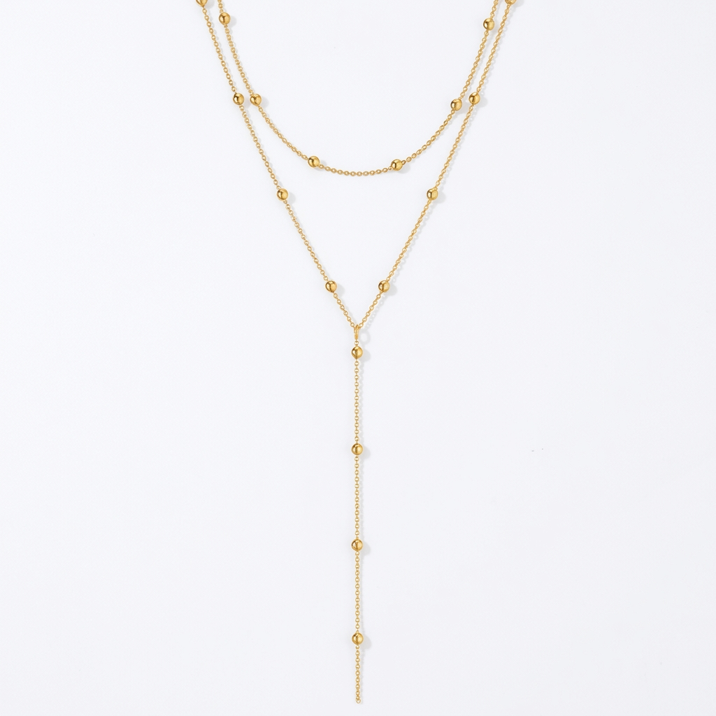 Gold-tone layered necklace on white