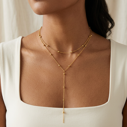 Gold-tone layered necklace worn by a model