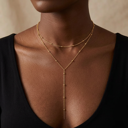Gold-tone layered necklace worn with a black top