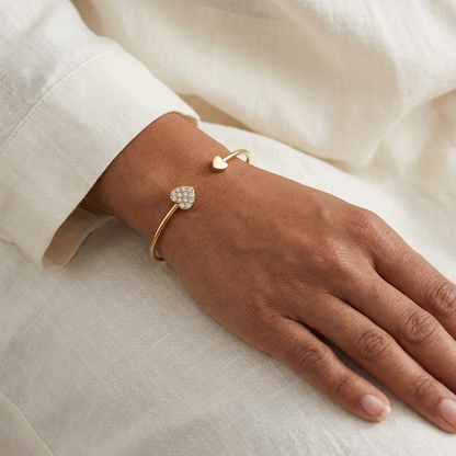 Heart cuff bracelet worn on a model’s wrist