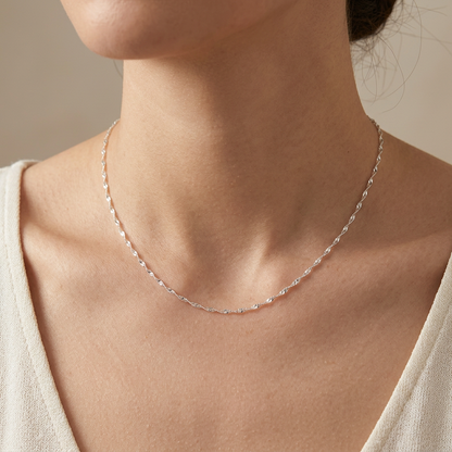 Silver necklace worn on a model