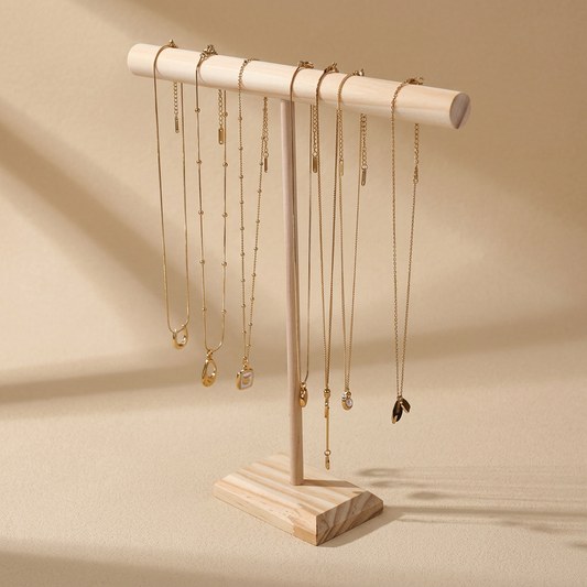 Wooden jewellery stand in a minimalist studio setting